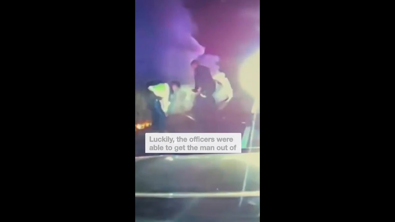 Shocking moment police rescue driver from burning car – The Australian News